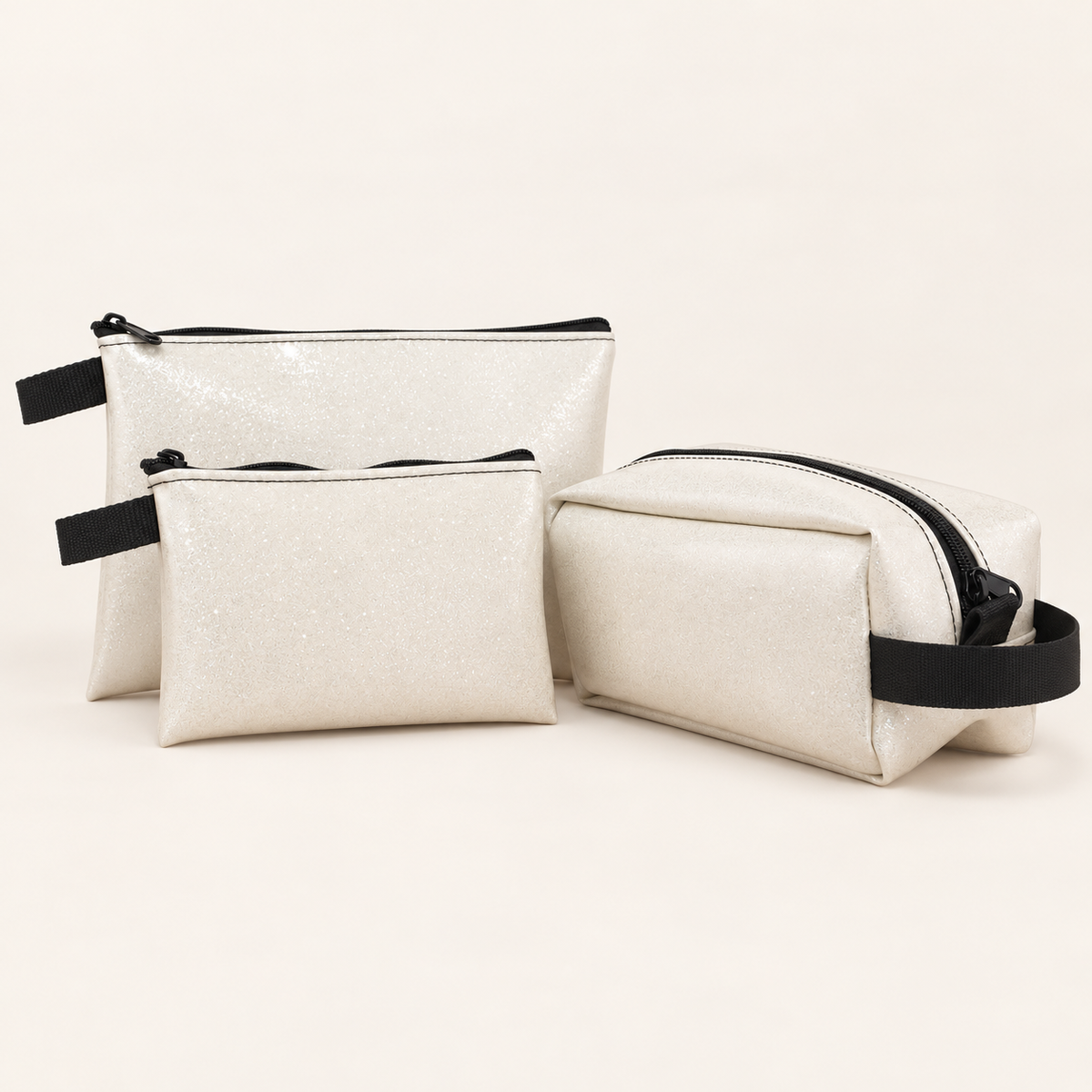 white small, large and Dopp sparkle pouches; sold separately